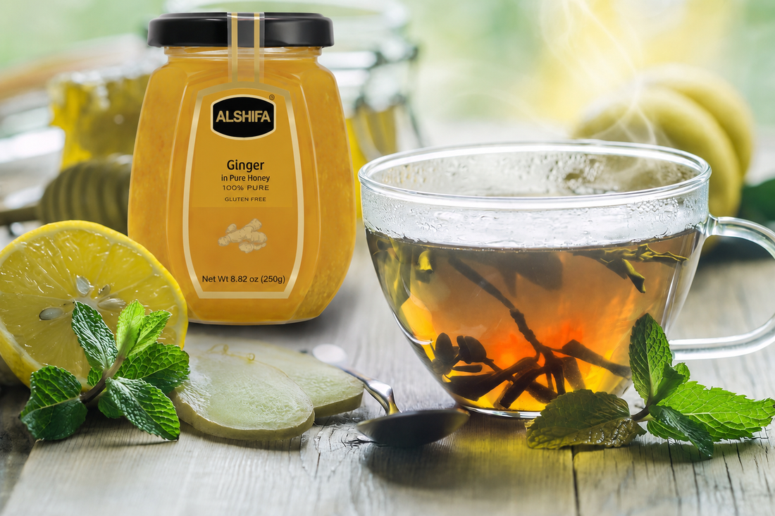 Cup of spiced tea with lemon, mint, and fresh ginger beside a jar of ALSHIFA Ginger in Pure Honey