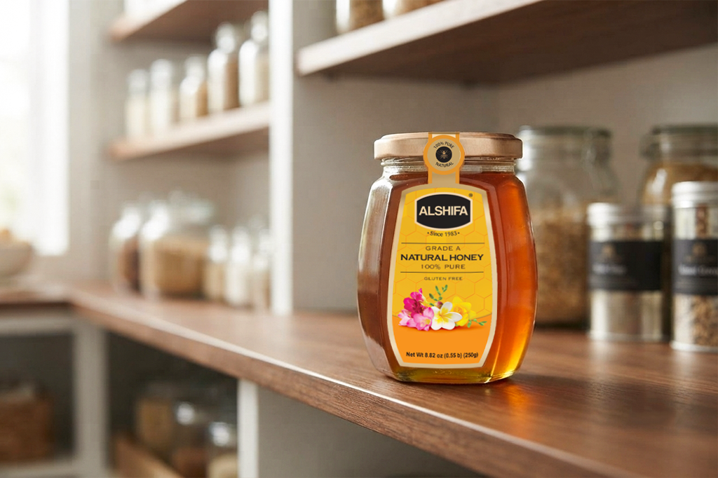 Sealed ALSHIFA Natural Honey glass jar stored on a wooden pantry shelf